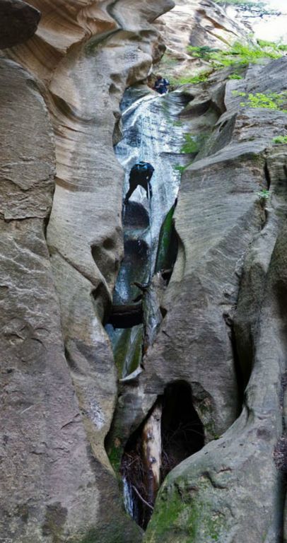 Panorama of Chad Utterback rappelling the waterfall in Boundary Canyon in Zion National Park with Tim Barnhart looking from top.