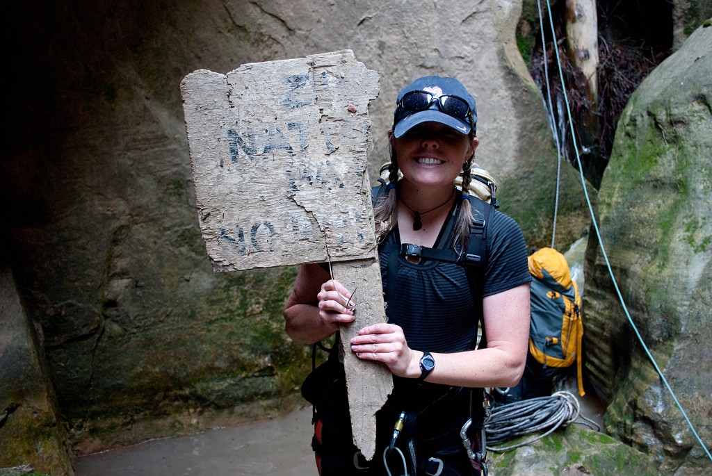 Cami Pulham holding the boundary sign to Zion National Park