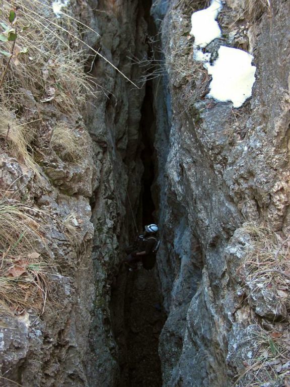 Climber in entrance to Hidden Cave