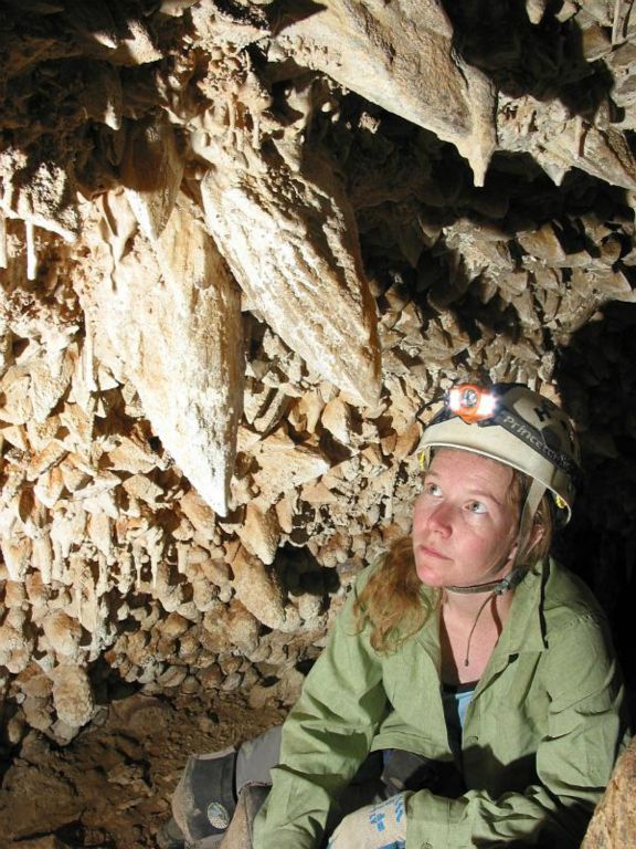 Jennifer Foote with large calcite crystals in Idono Crystal Cave