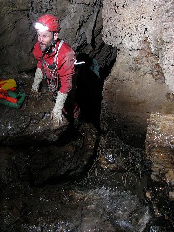 Heading in the stream pinch in Cueva de Atanacio.  Photo by Brandon Kowallis