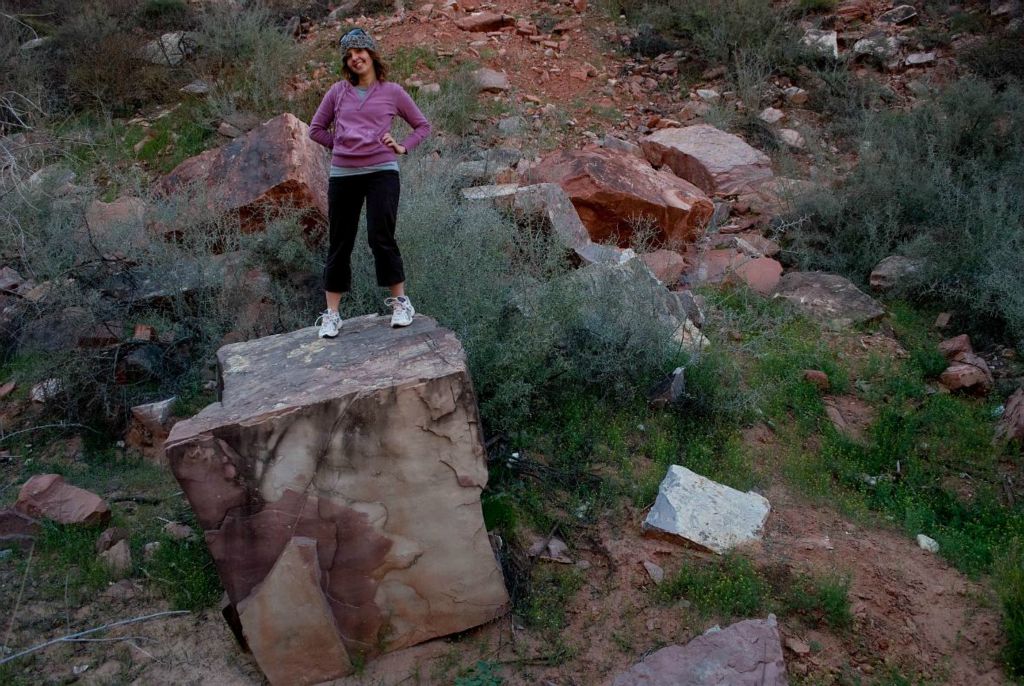 Janel Macy on top of small rock cube.