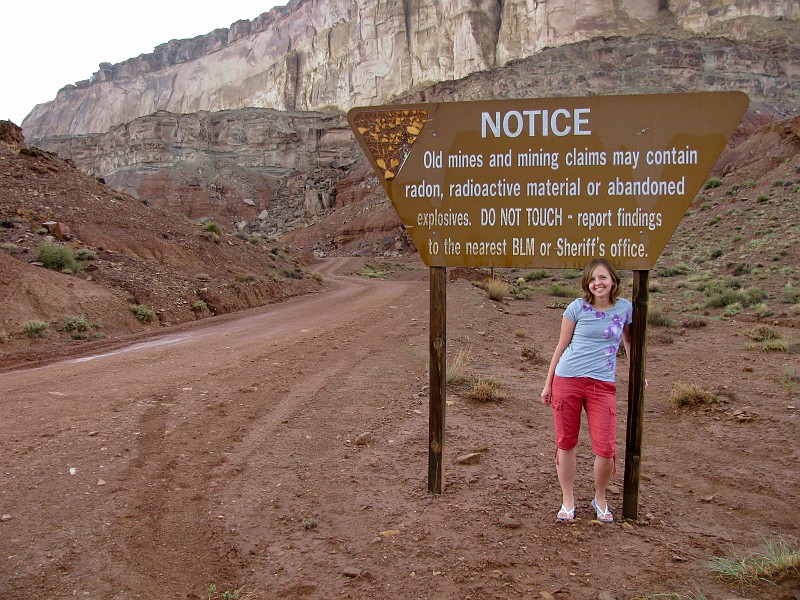 Janel Macy in front of the Notice posted at Tomisch Butte reguarding the radioactive mines.  Photo by Janel Macy.