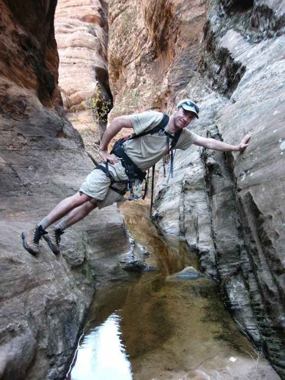 Shaun Roundy chimneying pass water obstacles in Behunin Canyon.  Photo by Shaun Roundy.