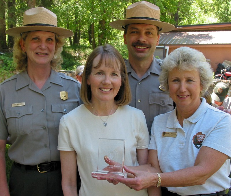 Anita Pulham recieved volunteer award from Director Fram Manlia with Kit Mullen and Mike Gosse.