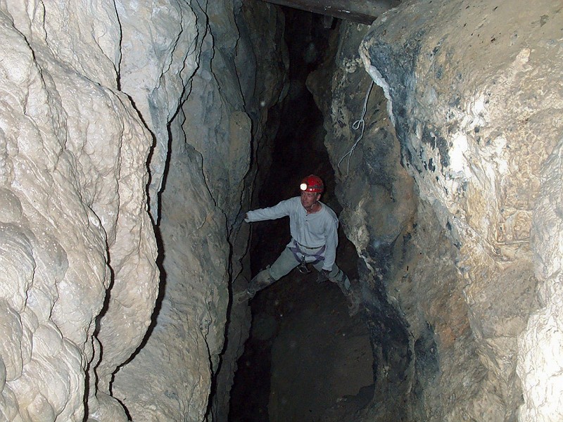 Jon Jasper at the base of the historic ladder in Middle Cave.
