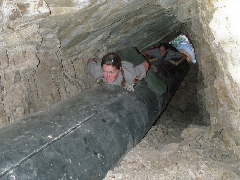 Cami Pulham and Trisha Sorber crawling through the pipeline tunnels.