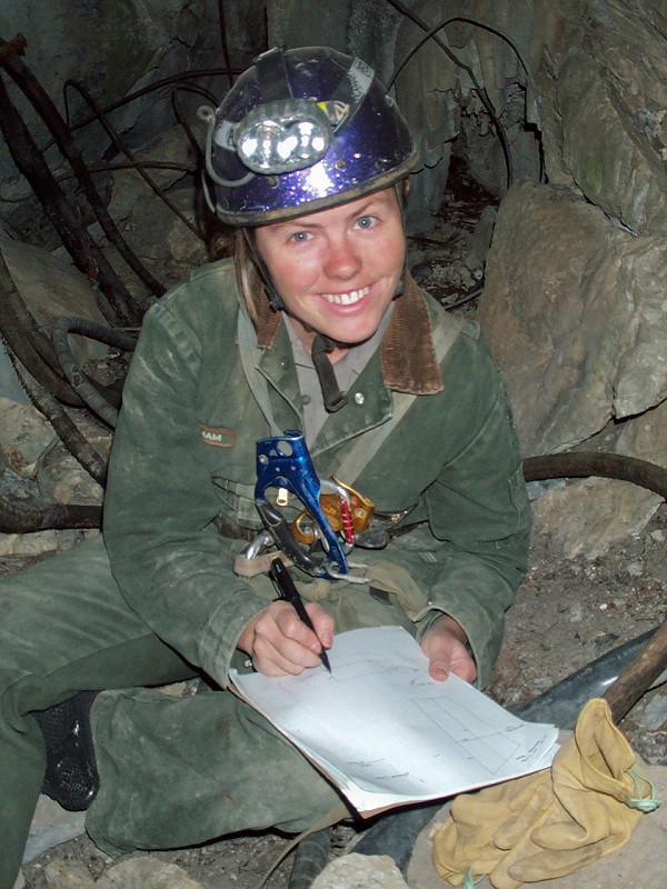 Cami Pulham drawing a sketch of the gate in the entrance to Middle Cave.