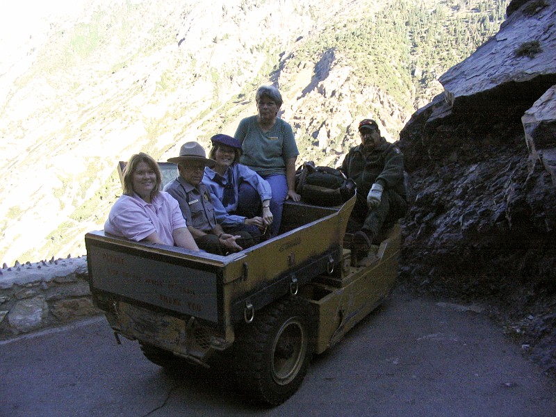 Dino Robinson delivery employees, Jenifer Yates, Arlo Shelly, Anita Pulham, and Helen Carlson, to the cave.