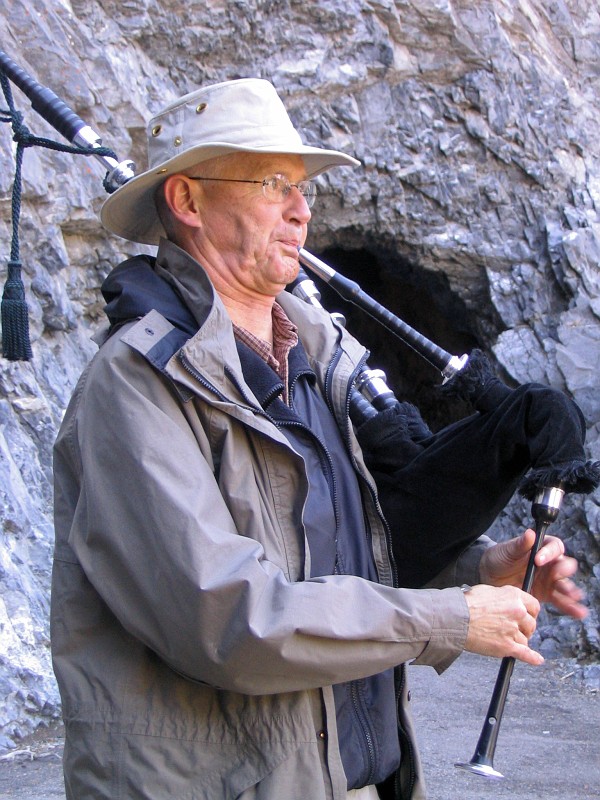 Chuck Acklin playing bag pipes at Hansen Cave entrance.