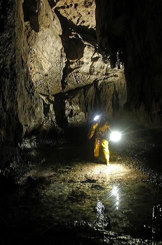 Brandon Kowallis in the horizontal passage in the bottom of Main Drain Cave.  Photo by Brandon Kowallis