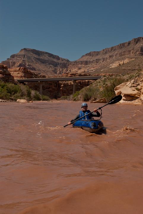 Tim Barnhart boating down the Virgin River at the first I-15 bridge in the Paiute Wilderness.