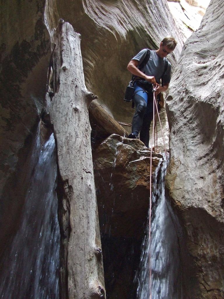 Jon Jasper rappeling the many logjams in Oak Creek Canyon.  Photo by Tim Barnhart