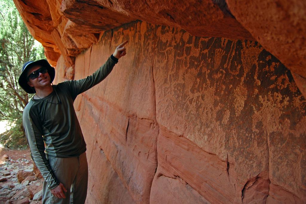 Tim Barnhart showing petroglyphs near the junction of Rock Canyon and Parunuweap Canyon.
