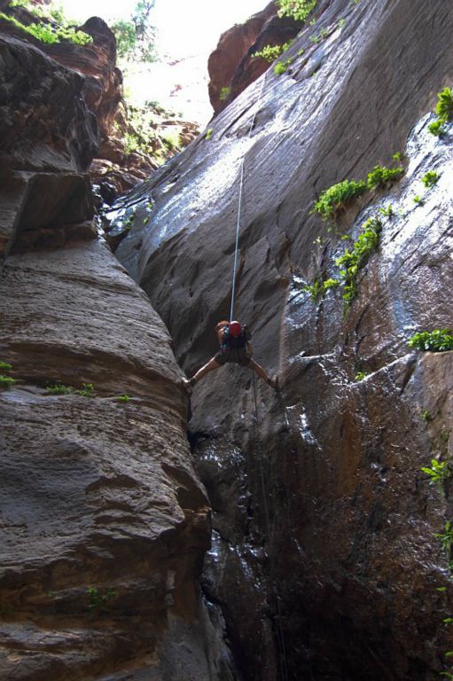 Megan Porter preparing to swing out of the watery finish of the Mystery Spring rappel.  Photo by Janel Macy.